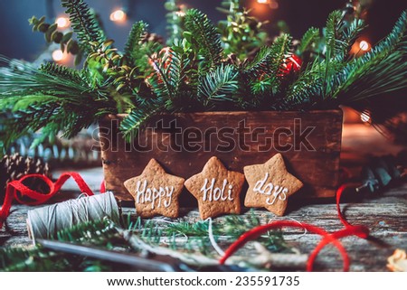 Evergreen Christmas centerpiece with Happy holidays gingerbread cookies and lights