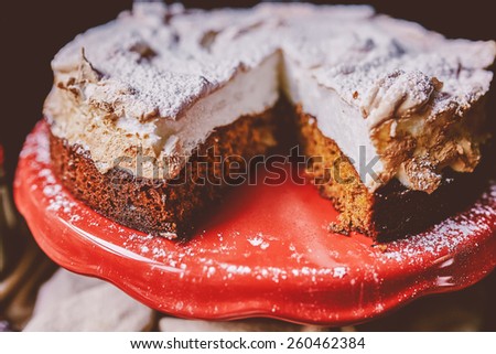 Sliced cake on a red cake stand
