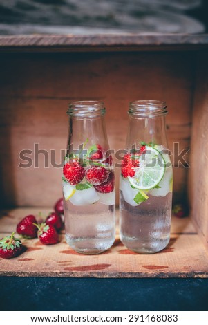 Chilled summer drinks in a bottles on a rustic background