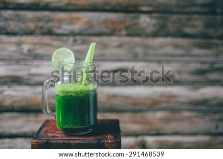 Green smoothie with lime and celery sticks