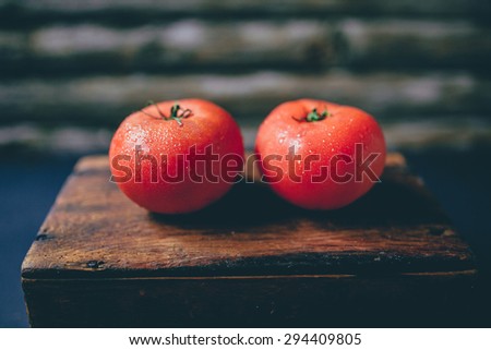 Greenhouse tomatoes on a rustic background