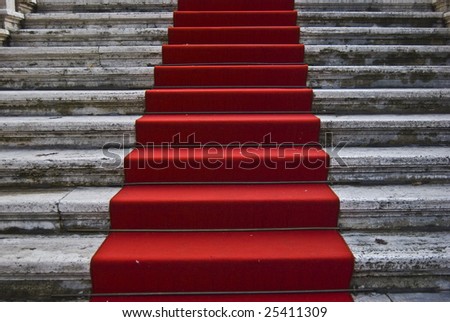 dirty red carpet leading up a staircase