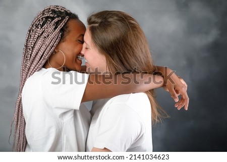 Similar – Image, Stock Photo Positive multiethnic couple kissing on street