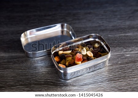 Trail mix inside a stainless steel snack box. Plastic alternative. Reusable many times over, airtight, compact and waterproof. Great choice for on the go. Zero waste journey, sustainability concept. Stock fotó © 