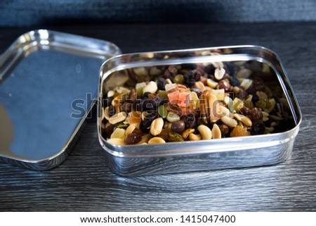 Trail mix in stainless steel container. Soft plastic bag alternative. New Zealand supermarkets are offering bring your own container for, meat, deli, bulk bins. Consumer change, sustainability concept Stock fotó © 