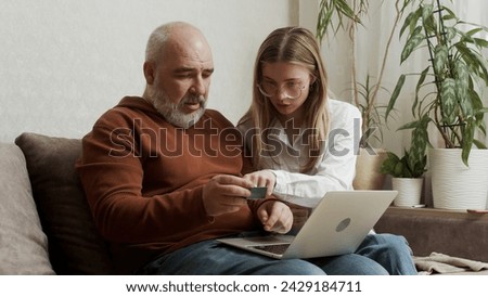 Similar – Image, Stock Photo Adult daughter teaching her elderly mother to use laptop