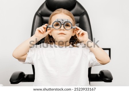 Similar – Image, Stock Photo child wearing glasses and writing while being really concentrated