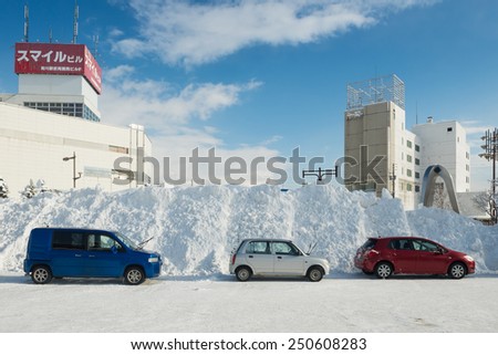 TAKIKAWA, HOKKAIDO, JAPAN - JANUARY 10, 2015: Snow piled higher than cars. Hokkaido is the most snowy area in Japan.