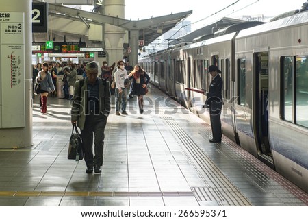 TAKATSUKI, JAPAN - NOVEMBER 30, 2014: Middle aged man and station staff.