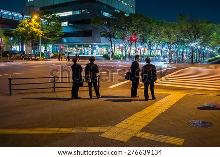 OSAKA, JAPAN - APRIL 23, 2015: Businessmen waiting for green light signal.