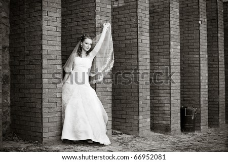 black and white portrait of the bride near the stone wall