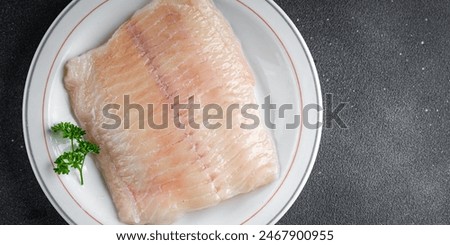 Similar – Foto Bild Zubereitung von Bass-Fischfilets in mediterraner Sauce mit Tomaten, Oliven und Kapern in einer Backform auf rustikalem Holzgrund mit Zutaten. Ansicht von oben