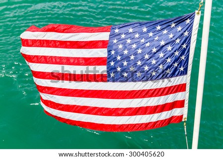 CHICAGO, USA - MAY 24, 2014: The American flag waving over water