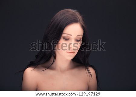 beautiful woman face and shoulders over dark background
