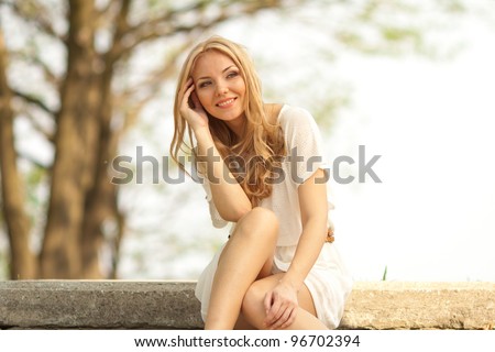 portrait of blond woman in white dress outdoor