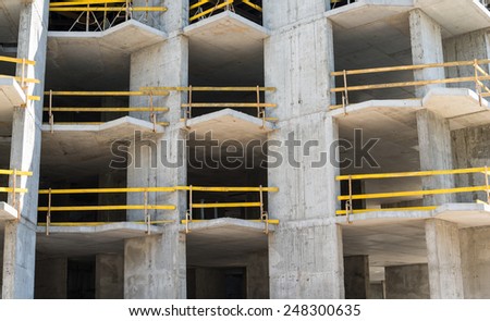 Grey concrete framework of the future building in the construction site