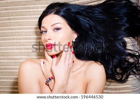 image of closeup portrait on attractive sexy girl, tempting brunette beautiful young woman with blue eyes, red lipstick & nails looking at camera