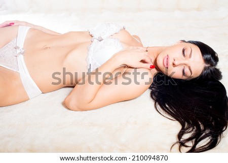 luxury brunette glamor lady in excellent fitness shape having fun calm relaxing in underwear eyes closed on light copy space background, portrait image
