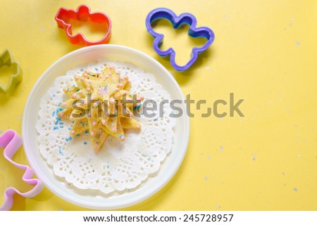 image of hand made cake or cookies on white plate with molds around