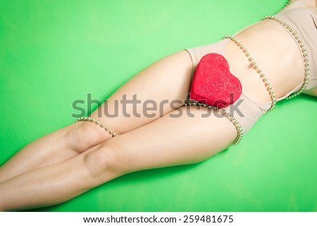 Picture of romantic sexy young lady having fun enjoying present in the form of heart relaxing lying on copy space background