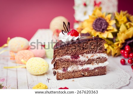 Picture close up on set of cake, colorful eggs and gift decorations