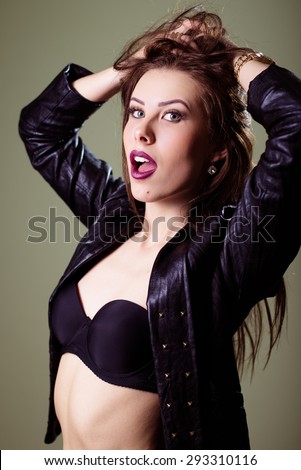 Portrait of hot sexy pretty young lady wearing leather jacket