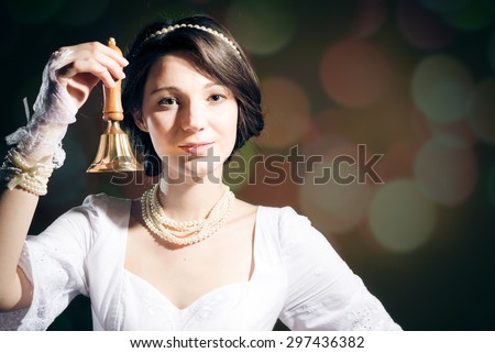 Picture of  pretty young lady  holding ring bell