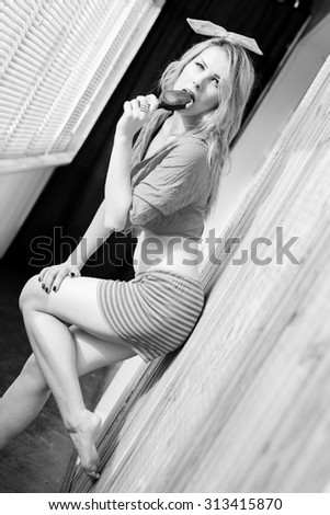 Picture of beautiful sexy blonde girl enjoying eating icecream. Black and white image