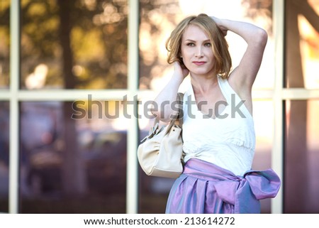 Beautiful girl in a shop window in the afternoon