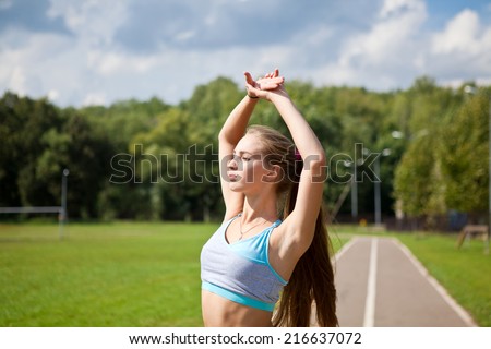 Beautiful athletic girl goes in for sports in the nature in the summer. Morning exercises