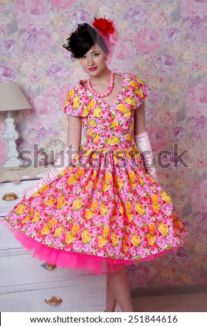 beatiful young girl with bright vintage dress posing in old room.isolated portrait
