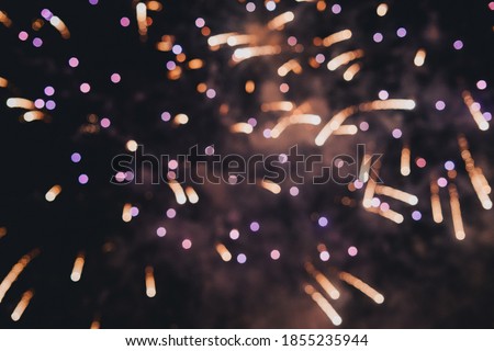 Abstract photo of fireworks. Salute without focus. Blurry photo of fireworks. Festive fireworks. A beautiful flicker of fireworks. Selective focus.