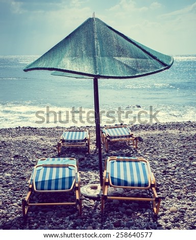 Beach umbrella green beach deck chair ocean sea water greece peaceful relax unwind black sand