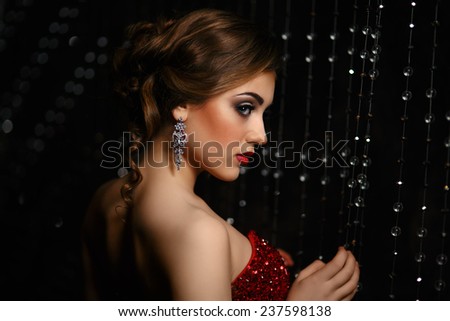 closeup fashionable woman on black background flirty looking