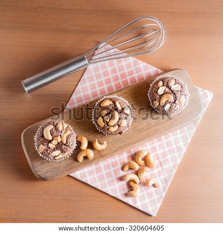 Cup of Chocolate Cake Brownies With Cashew nuts On Wooden Background