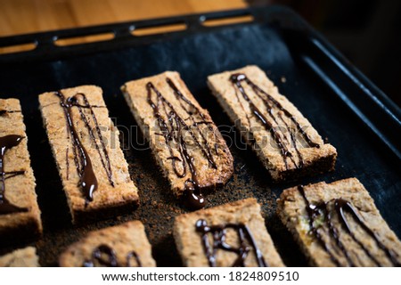 homemade protein m?sli bar with banana and oatmeal decorated with dark chocolate as a healthy alternative without sugar, presented on the baking tray Stok fotoğraf © 