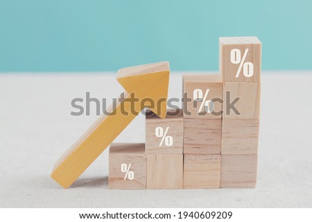 Wooden blocks with percentage sign and arrow up, financial growth, interest rate increase, inflation concept