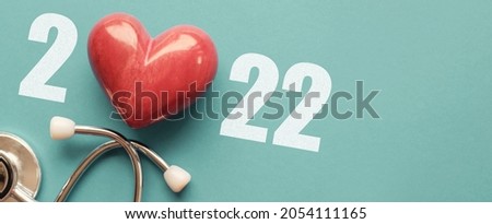 2022 with Red heart nad stethoscope, heart health,  health insurance concept, new year resolutions goal