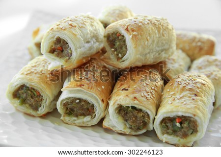 Homemade sausage rolls on white plate