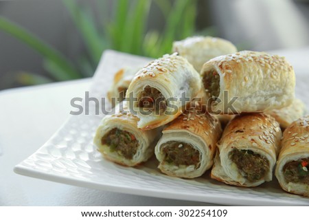 Homemade sausage rolls on white plate