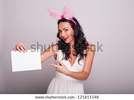 Happy smiling young beautiful  woman showing paper for sign or copyspase, isolated on white background