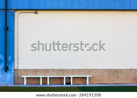 concrete bench in sport stadium and abstract grunge wall. Copyspace for your text. For presentation.