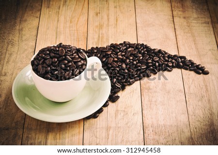 Cup full of coffee beans on wood ,Vintage style ,Still life