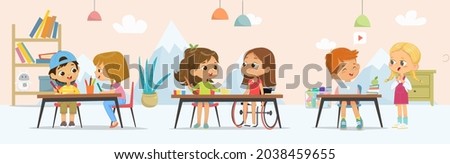 School Class.Girl with a disability in a wheelchair, children in the play playroom. School inclusive education concept.Drawing activity in the art class. Boy and Girl draw pictures with paints 