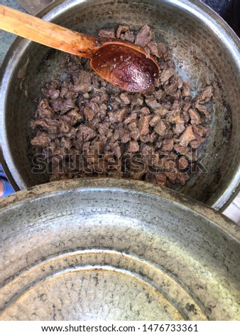 Muslims Traditional Sacrifice holiday food lamb, Turkish roasted meat in copper pot on table top view with wooden spoon. Turkish Kavurma. Stok fotoğraf © 