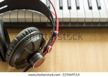 Composer workplace. Headphones and keyboard. Computer music concept.