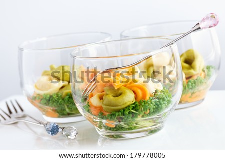 Italian tortellini salad with cheese tomato sauce and micro greens