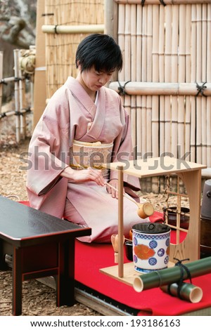 TSUKUBA, JAPAN - MARCH 10: Japanese woman in traditional kimono prepares the tea ceremony at tea house on March 10, 2013 in Tsukuba, Japan. Taken in a plum garden on Mt. Tsukuba.