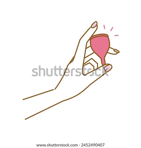 Women's health: image of a beautiful woman's hand holding a menstrual cup, a sanitary product