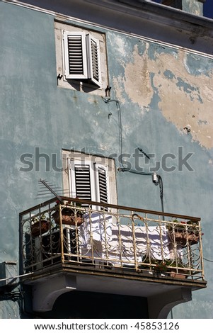 old balcony at a blue house at the old town of Cres, Croatia